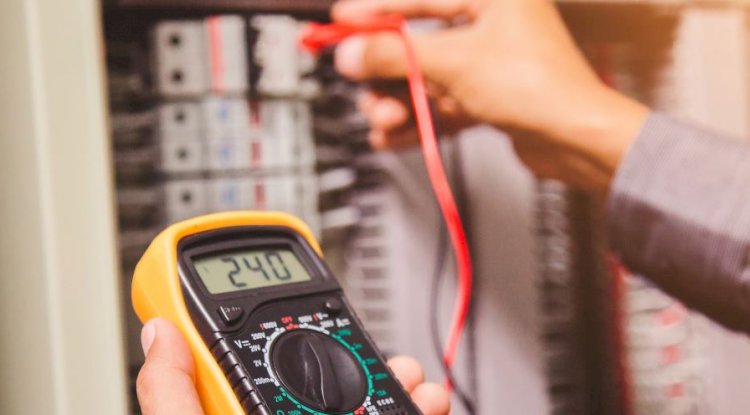 Electrician using multimeter